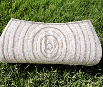 Vogue Crafts & Designs Pvt. Ltd. manufactures White Beady Clutch at wholesale price.