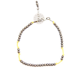 Vogue Crafts and Designs Pvt. Ltd. manufactures Yellow String and Silver Ball Anklet at wholesale price.